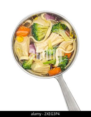 Chicken noodle soup in ladle isolated on white background, top view Stock Photo