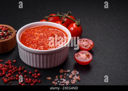 Delicious hot spicy red sauce with salt and spices in a ceramic bowl Stock Photo