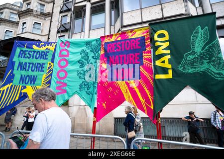 London, UK. 22nd June 2024. Banners in a row at the Restore Nature Now protest demonstration in London, calling for urgent political action on the nature and climate emergencies. Stock Photo