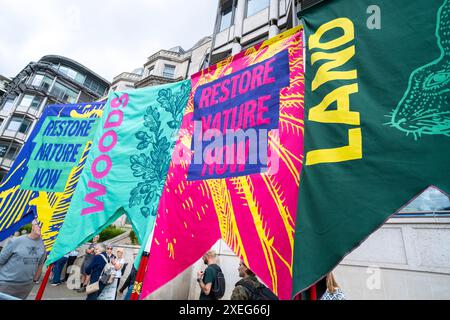 London, UK. 22nd June 2024. Banners in a row at the Restore Nature Now protest demonstration in London, calling for urgent political action on the nature and climate emergencies. Stock Photo