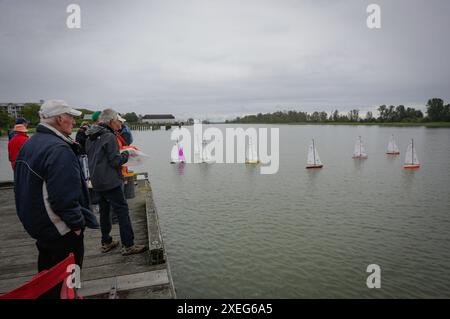 Richmond, Canada. 27th June, 2024. People participate in an event of racing radio controlled sailboats at Steveston Harbour in Richmond, British Columbia, Canada, on June 27, 2024. Radio-controlled sailing has become increasingly popular in Canada, attracting enthusiasts of all ages. Credit: Liang Sen/Xinhua/Alamy Live News Stock Photo