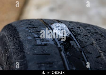 soapy water and bubbles used to locate a hole in a flat tire Stock