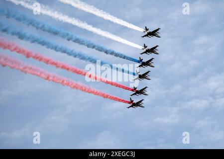 MOSCOW, RUSSIA - MAY 7, 2021: Avia parade in Moscow. Group of Russian fighters Sukhoi Su-25 with painted russian flag in the sky Stock Photo