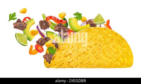 Mexican taco with falling beef meat and vegetables isolated on white background Stock Photo