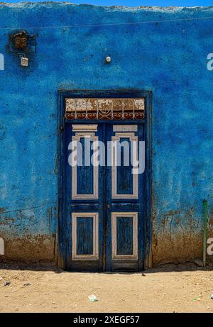 Blue door and Blue Wall on a house near Medinet Habu Temple in Luxor, Egypt Stock Photo