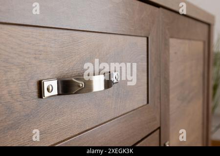 Metal handle on brown drawer, interior, close-up Stock Photo
