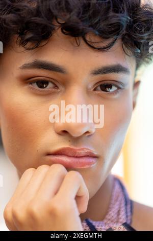 Close-up of transgender transgender woman resting chin on hand, looking thoughtful Stock Photo