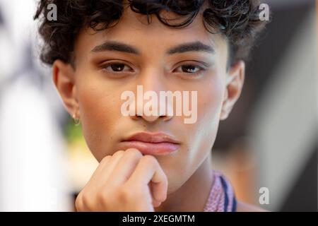 Close-up of thoughtful transgender transgender woman resting chin on hand, looking pensive Stock Photo