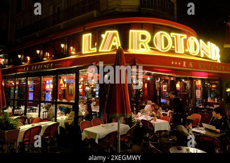 The night view of Cafe de La Rotonde, a famous historic brasserie and restaurant in Montparnasse Quarte of Paris.Paris.France Stock Photo