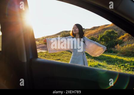 A young attractive Asian woman is smiling and enjoying the mountains Stock Photo
