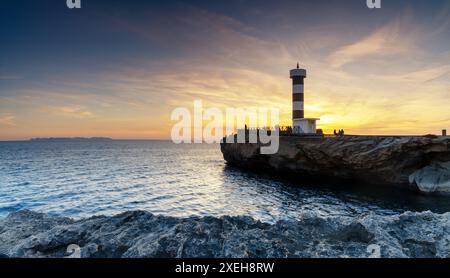 View of the lighthouse at Colonia Sant Jordi in Mallorca at sunset Stock Photo