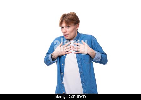 Young surprised european man with copper hair dressed casually in a blue shirt Stock Photo
