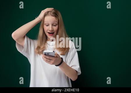 Woman Holding Cell Phone and Looking at It Stock Photo