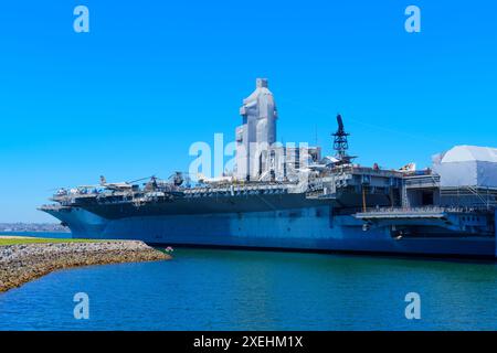 San Diego, California - April 16, 2024: Large aircraft carrier docked in San Diego harbor on a sunny day. Stock Photo