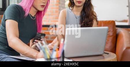 LGBTQ+ transgender man Beautiful Authentic SpecialistÂ with Pink Hair and Non-binary trans working together Working Design in cr Stock Photo
