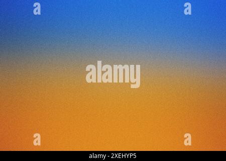 Grainy texture image with a smooth gradient from blue to orange, evoking a sunset sky Stock Photo