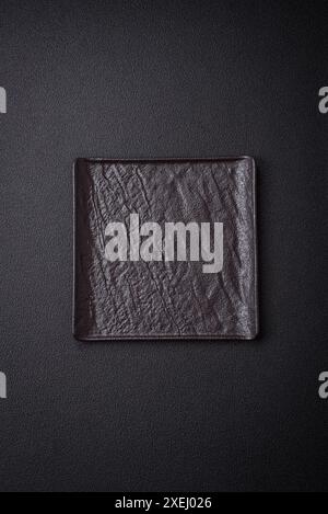 Square empty ceramic plate on textured concrete background Stock Photo