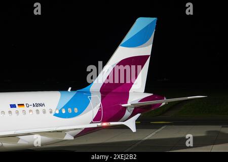 Graz, Austria - September 24, 2023: Tail with company logo of low cost airline Eurowings as part of Lufthansa Group at night on Stock Photo