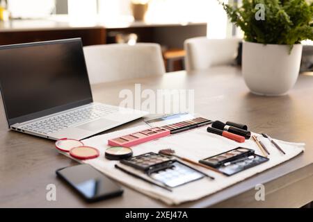 Makeup tools and laptop on table, preparing for online beauty tutorial at home Stock Photo