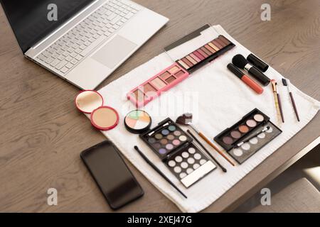 Makeup products and laptop on table, preparing for online beauty tutorial Stock Photo