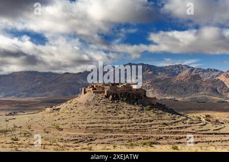 Landscape view of the Altas mountains in Morocco with the Kasbah Tizourgane on the hilltop in the centre Stock Photo