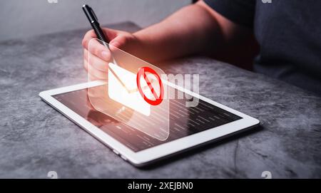 Woman use digital Tablet to block spam e-mail. Warning pop up of phishing mail. Internet security concept. Business woman working on digital Tablet. Stock Photo