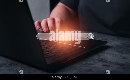 Woman use laptop with holographic digital search bar. Internet of things. Concept of searching browsing Internet data information. Stock Photo