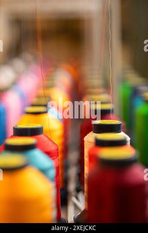 Spools of colorful thread in rows vertical Stock Photo