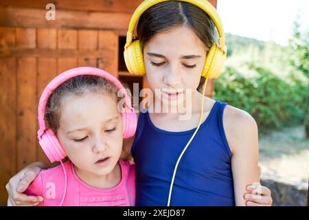 portrait of two smiling sisters standing in sportswear Stock Photo