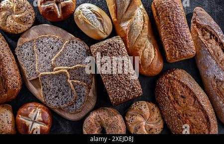 Assorted bakery products including loaves of bread and rolls. Stock Photo