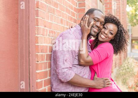 Young couple holding each other smiling at camera Stock Photo