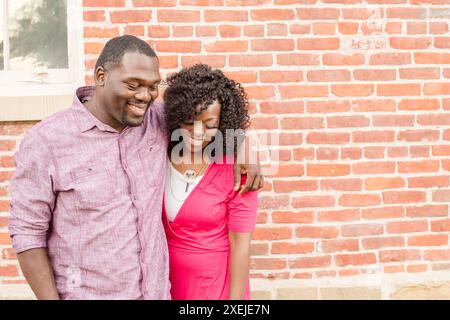 Couple walking together, man has his arm around girlfriend in fr Stock Photo
