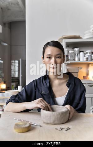 Asian ceramics Artist is shaping clay in studio Stock Photo