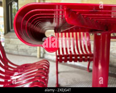 Red lacquer table and chairs on white tile on public library porch Stock Photo