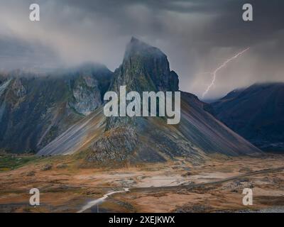 Lightning Strike Illuminates Dramatic Mountain Range in Iceland Stock Photo