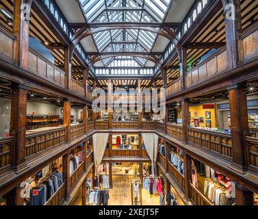 London, United Kingdom - June 25, 2024: Wooden interior and the ceiling of Liberty store, tudor Revival style building with exclusive fashion, luxury Stock Photo