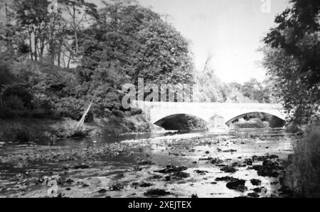 Ribble Bridge in Gisburn, a village in the Ribble Valley, Lancashire. Cycling tour, 1937. From an album which covered a journey by bicycle in the UK by a group of enthusiastic cyclists. The album was compiled and annotated by an amateur photographer and the tour included North Wales, Yorkshire, Lancashire and Cumbria. There was no indication of who compiled the album. Original photograph sizes varied, the smallest being about 3x2 inches, the largest about 7x5. Stock Photo