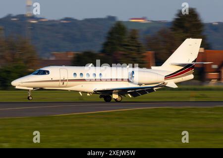 Private Jet airplane landing on a runway Stock Photo