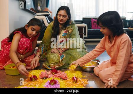 Mom Making Flower Composition With Her Children Stock Photo