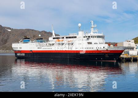 HonningsvÃ¥g, Norway - June 11, 2023: Hurtigruten postal ship in the port of HonningsvÃ¥g in the polar region Finnmark in Norway Stock Photo