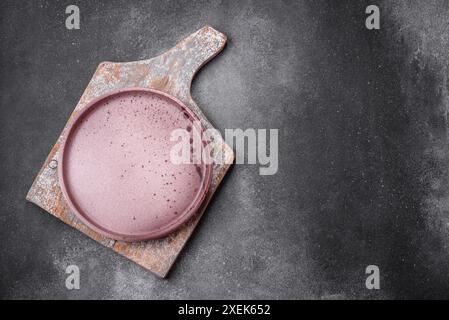 Empty round ceramic plate on a light texture background Stock Photo