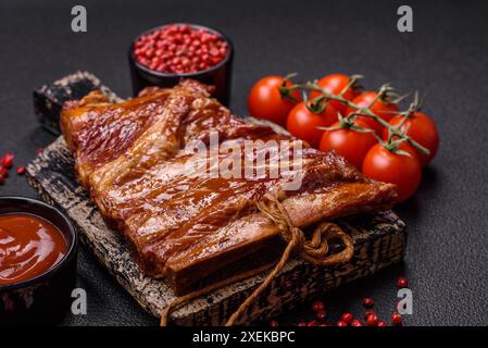 Delicious smoked or grilled ribs with olives, spices and herbs Stock Photo