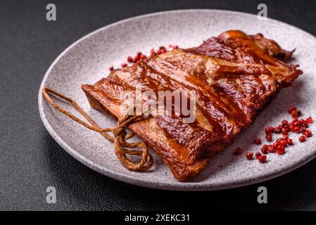 Delicious smoked or grilled ribs with olives, spices and herbs Stock Photo