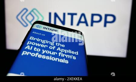 Mobile phone with website of US software company Integration Appliance Inc. (Intapp) in front of logo. Focus on top-left of phone display. Stock Photo