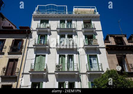 Residential building with decorative balcony railings and rooftop patio in Madrid; Madrid, Spain Stock Photo