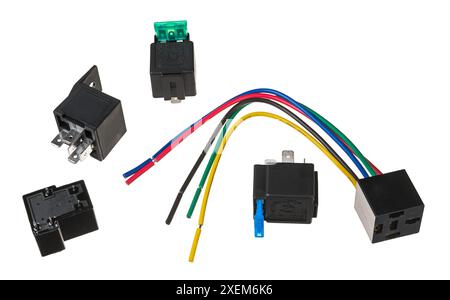 Closeup of electrical automobile relay isolated on white background. Set of automotive electromechanical switches with green and blue blade type fuses. Stock Photo