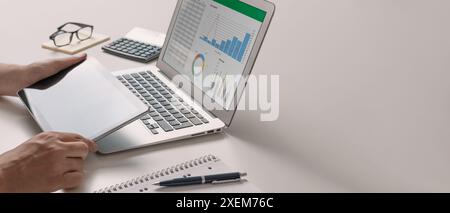 Financial and budget planning with chart report. Man using digital tablet and laptop Stock Photo