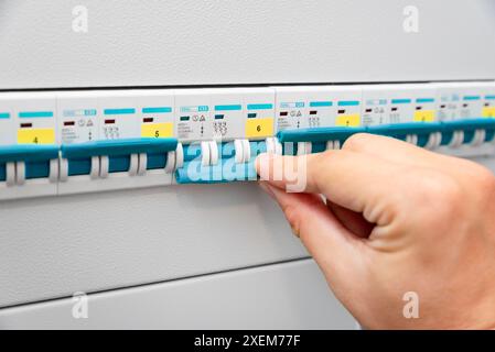 Turning off the power. Hand switch electric fuse Stock Photo