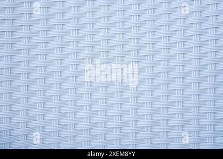 white plastic weave texture pattern. This is a popular pattern for mats, baskets or furniture. Handmade weaving pattern for background Stock Photo