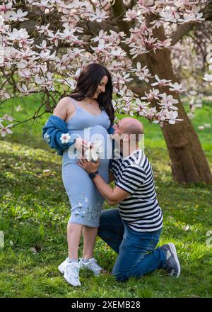 Happy family enjoying life near the Christmas tree Stock Photo - Alamy